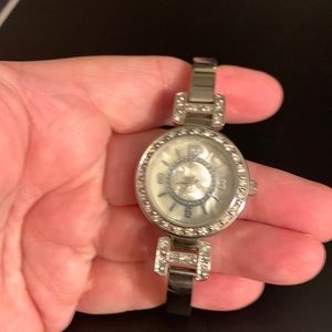 Silver Watch with Pearl background on the face of the watch.